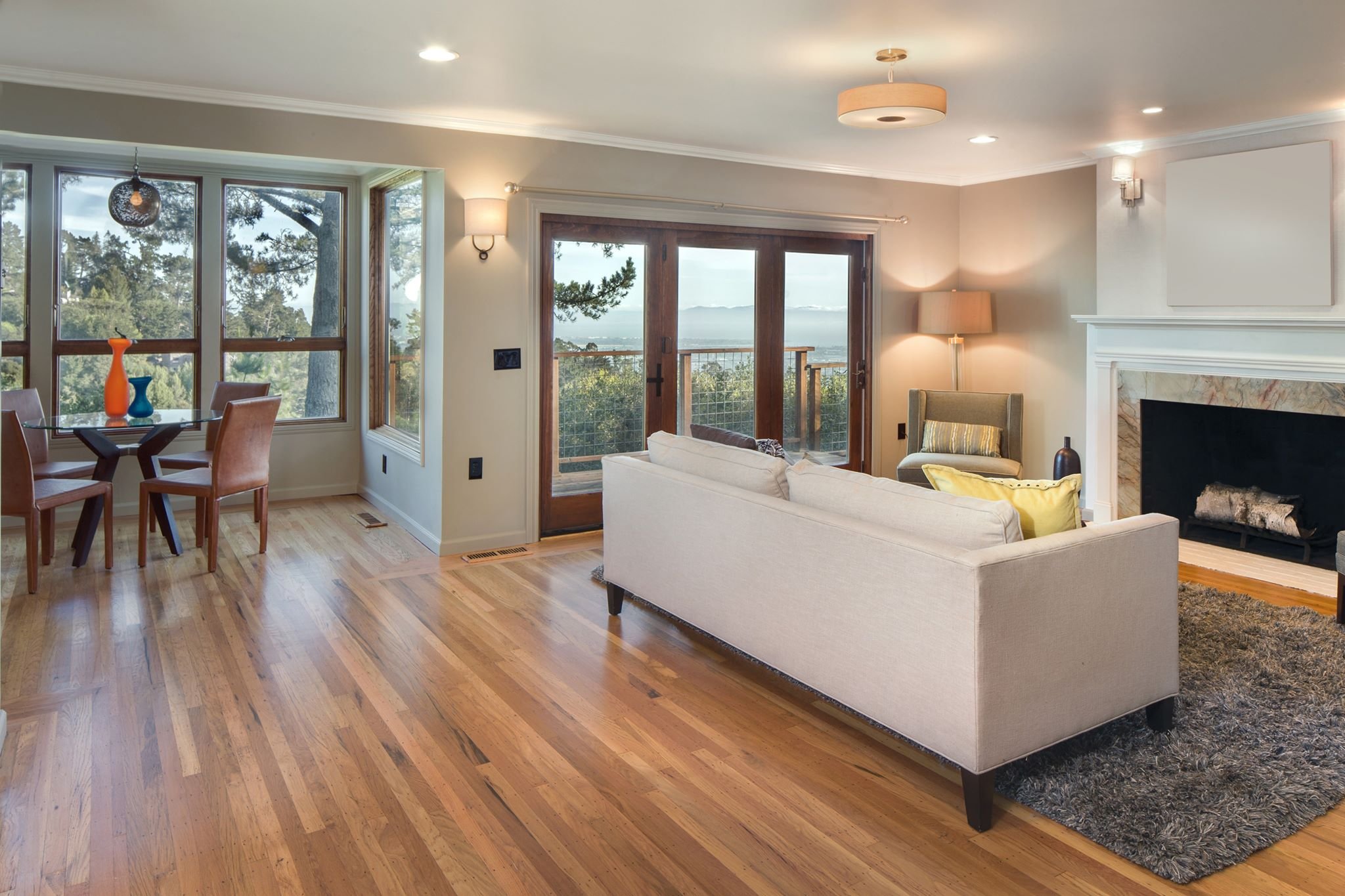 white couch in a living room with a brown hardwood floors from Budget Flooring & Shutters in Las Vegas, NV