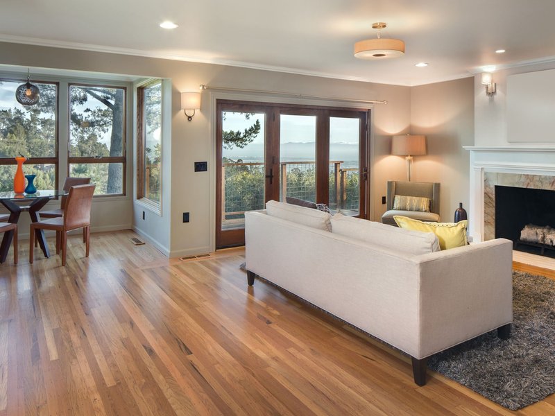 white couch in a living room with a brown hardwood floors from Budget Flooring & Shutters in Las Vegas, NV