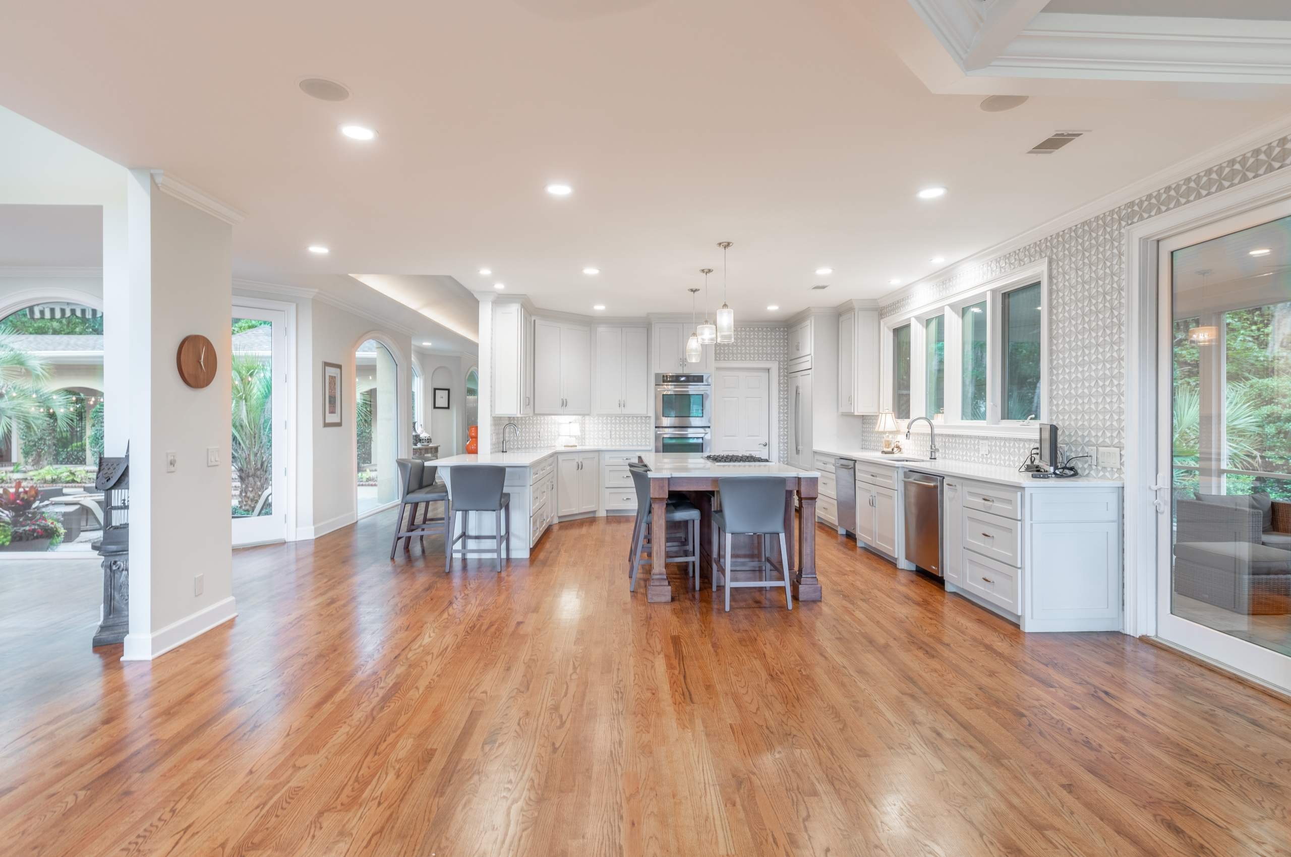 white living cabinets on a brown hardwood floor from Budget Flooring & Shutters in Las Vegas, NV